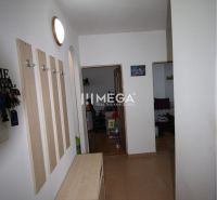 A hallway in a 2-room apartment with a coat rack and a shoe cabinet.