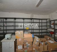 Warehouse commercial space with shelves and boxes.