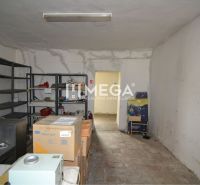Interior of commercial premises with shelves and cardboard boxes.