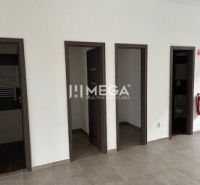 Interior of commercial premises with tiling and multiple doors.