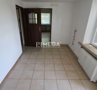 Interior of a 3-room apartment with tiles and wooden doors, illuminated by daylight.