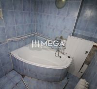 A bathroom with blue tiles and a bathtub in a 3-room apartment.