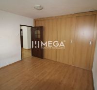 A room in a 3-room apartment with a wooden decor floor and a built-in wardrobe.