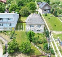 A family house on Jesenského Street in Snina surrounded by a garden and neighboring houses.