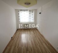 A narrow room with a window and a wooden decor floor in a 3-room apartment.