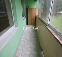 Glazed loggia with tiles and a storage cabinet in a 3-room apartment.
