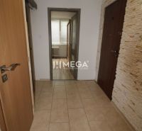 A hallway with light tiles in a 3-room apartment with entrance doors.