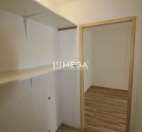 An entrance hall with shelves and a wooden decor floor in a 3-room apartment.