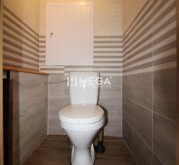 Bathroom in a 3-room apartment with tiles and a wooden decor floor.