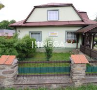 A family house in Ulič at the address Ulič 131 with a front garden and a wooden gate.