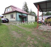 Family house on Ulič Street 131, with a garden, a car, and a shelter.
