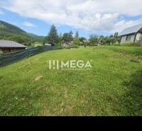Gardens in Snina in Snina with a lawn, fencing, and a view of the mountains in the background.