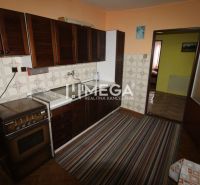 Family house kitchen with kitchen unit, carpet, and wooden decor flooring.