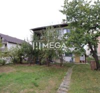 A family house in Snina on Snina Street with a large garden and fruit trees.