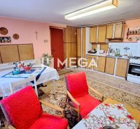 A kitchen in a family house with furniture and decorations, a floor with a wooden decor.