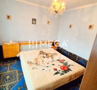 Bedroom with a bed and carpet pattern in a family house.