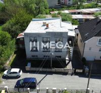 A family house on Gagarin Street in Snina surrounded by greenery and neighboring buildings.