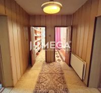 Interior of a family house with four rooms and wooden wall paneling.