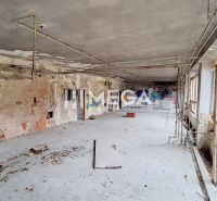 An abandoned room with peeling walls and graffiti in a building.