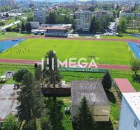 Athletic stadium and surroundings on Tyršova Street in Humenné with a view of the surrounding buildings.
