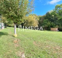 A residential plot in Staré offers a grassy area with fencing and trees.