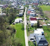 An aerial view of properties - housing with greenery and rural houses in the town of Staré.