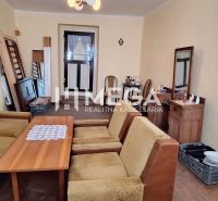 Living room in a family house with antique furniture and a sofa set.