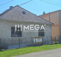 A family house in the village of Kochanovce on Kochanovce Street, fenced and with a surrounding garden.