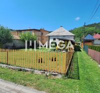 A family house in Kochanovce on Kochanovce Street with a front garden and a wooden fence.