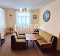 Living room in a family house with a sofa and wooden floor decor.