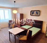 Interior of a family house with furniture, wooden floor decor, and paintings on the walls.