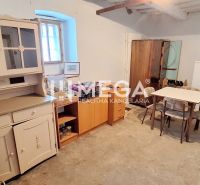 Interior of a family house with retro furniture, a console, a table, and chairs.