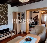 Living room in a family house with stone decoration and wooden decor flooring.