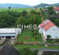 A plot of land in Oľšinkov suitable for living, surrounded by greenery and nearby houses.