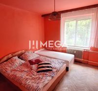Bedroom with a double bed and a window, 2-room apartment, floor with wood decor.