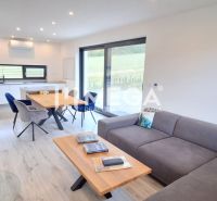 Living room in a family house with a wooden decor floor and a dining table.