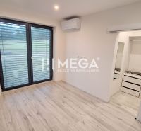 A room with air conditioning, a wooden decor floor, and a built-in wardrobe in a family house.