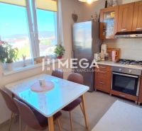 A kitchen in a 3-room apartment with a dining table and white walls.