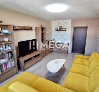 Living room with wood-patterned flooring, yellow sofa, wooden furniture.