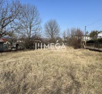 Lands - housing in Modra nad Cirochou, flat terrain, grassy vegetation, surrounding trees, urban development.