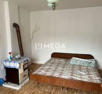 A room in a family house with a bed and a wooden decor floor.