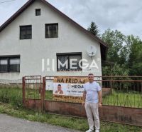 A family house in Zboj with a plot bordered by a metal fence and a large garden.