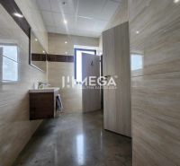 Bathroom with tiles and a sink in the office.