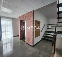 Interior of an office with a staircase, elevator, and curtain.