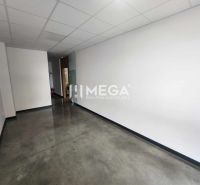 Office spaces with white walls and concrete decor flooring.