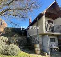A family house in the village of Viničky on Viničky Street with stone stairs and a balcony.
