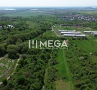 Aerial view of the Gardens in Trnava pri Laborci with green fields and buildings.