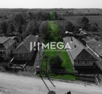 Exterior in Senné: plots - housing with greenery and access road.