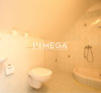 Bathroom with a bathtub, sink, and toilet in commercial premises.