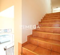 A staircase in commercial premises with light walls and doors.